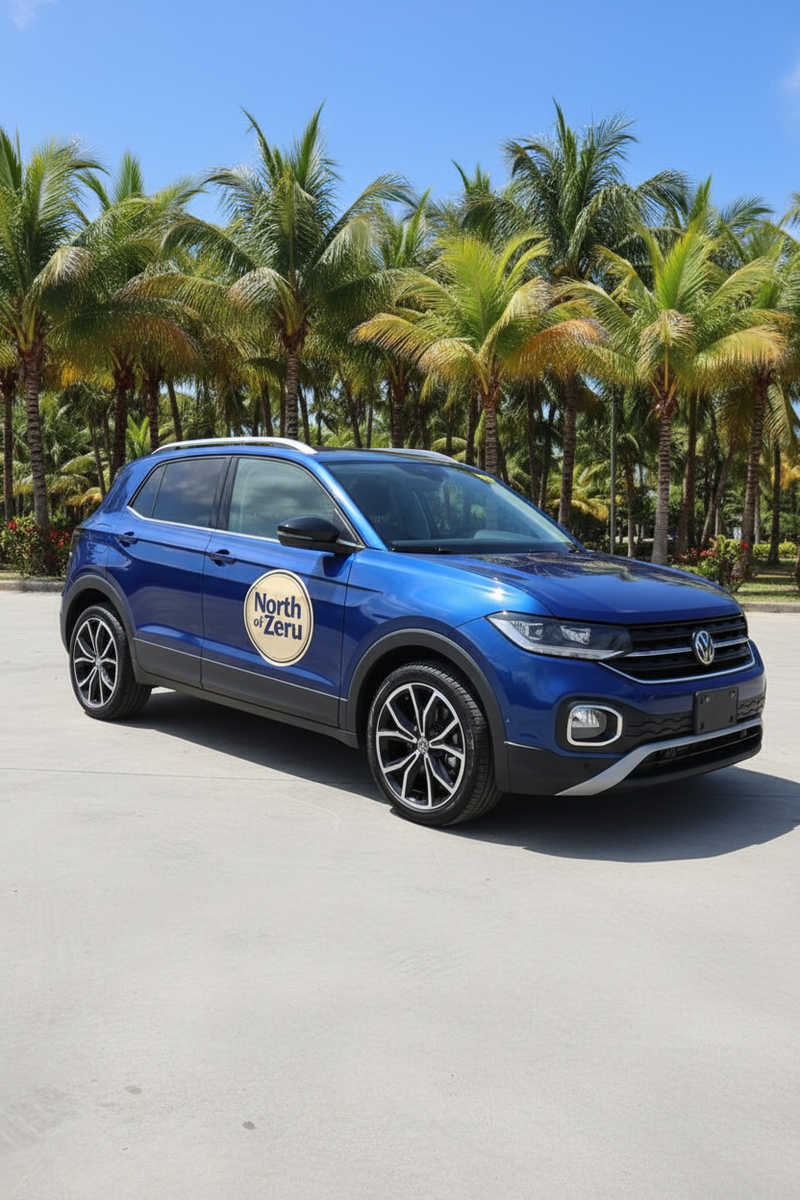 North of Zeru branded blue Volkswagen T-Cross with tropical background